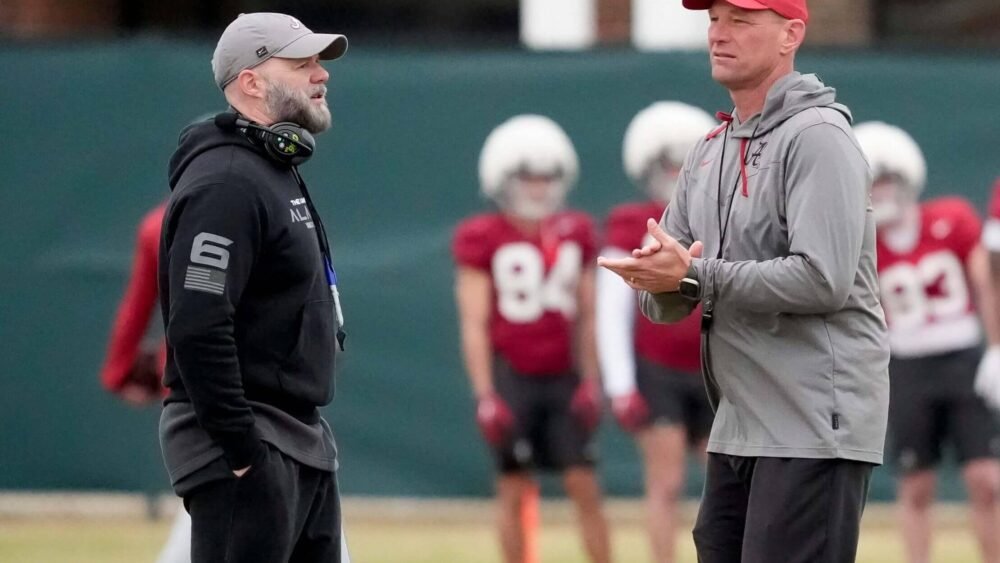 Alabama coach Kalen DeBoer speaks with offensive coordinator Ryan Grubbs