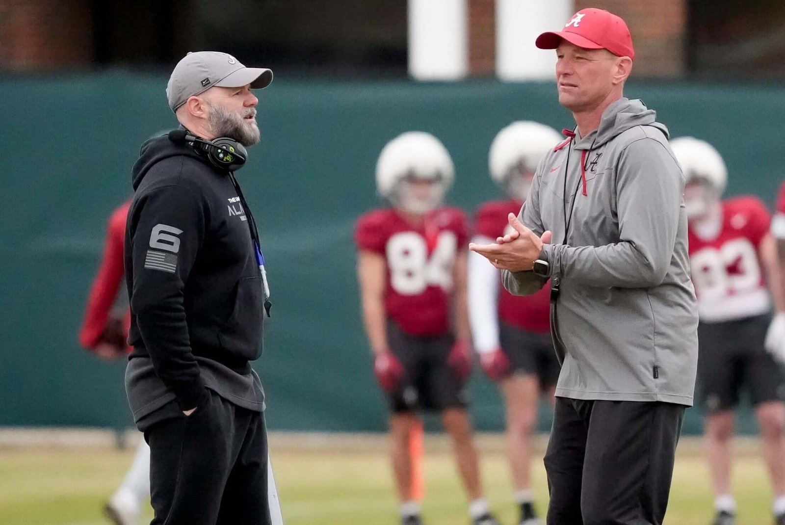 Alabama coach Kalen DeBoer speaks with offensive coordinator Ryan Grubbs